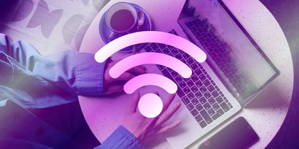 Person typing on a laptop with Wi-Fi logo overlay